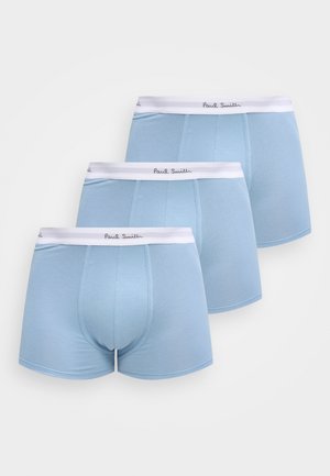 Trois boxers pour hommes bleu clair avec des ceintures élastiques blanches marquées "Paul Smith" empilés sur un fond blanc.