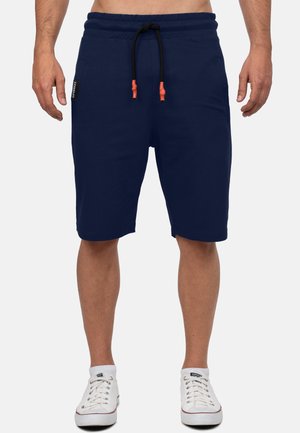 Shorts de sport bleu marine en coton, dotés d'une taille à cordon de serrage avec des accents orange, de poches latérales et d'une coupe décontractée.