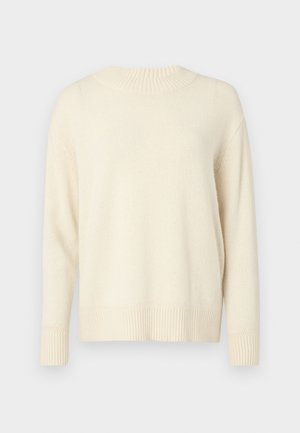 Kreemi värvi kootud sviiter ümmarguse kaeluse, pikkade varrukate ning rubriikidega mansettide ja alläärega. Pehme tekstuur ja lõtv istuvus. Mustrid pole nähtavad.