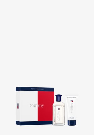 Tommy Hilfiger gift set featuring a clear glass bottle with a navy cap and a white tube labeled "Body Wash," presented in a color-blocked box.