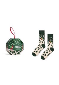 Boîte verte et crème avec des accents rouges, contenant des chaussettes à motifs représentant des arbres et des étoiles, étiquetée "HAPPY SOCKS" en vert.