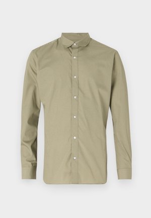 Camisa verde olivo de botón con cuello puntiagudo, de mangas largas y textura suave, con botones de plástico transparente en la parte delantera.