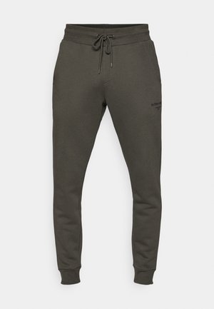 Dark olive green sweatpants made of soft fabric, featuring an elastic waistband with drawstring and ribbed cuffs; subtle logo detail on the leg.
