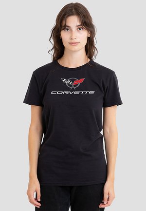 Black cotton t-shirt featuring a prominent Corvette logo in white and red, with checkered flag accents, crew neckline, and short sleeves.