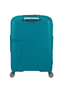 Valigia rigida turchese con texture rigata, una maniglia superiore e quattro ruote girevoli per una facile mobilità.