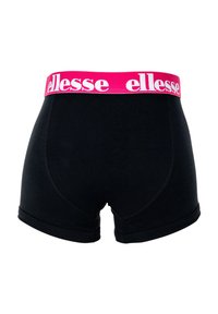 Mustat puuvillalayttimet, joissa on vaaleanpunainen joustavyötärö ja valkoinen "ellesse"-logo. Suunniteltu tiukasti istuvaksi ja sileäksi.