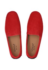 Røde ruskinds slip-on loafers med en glat tekstur og syede kanter. Indersålerne er tanfarvede med branding, og ydersålerne er sorte.