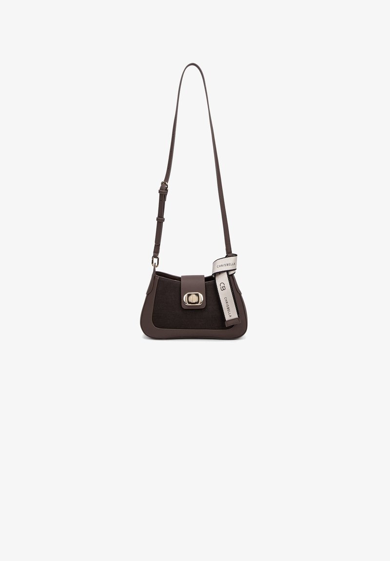 Brown leather handbag with a trapezoidal shape, featuring a front flap and metal buckle. Includes an adjustable strap and tag detail.