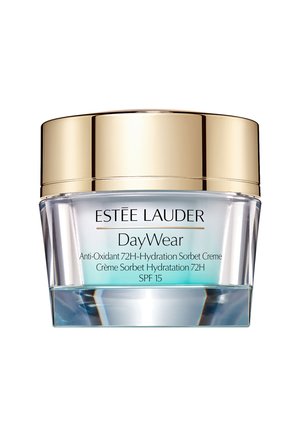 Sorbet crème hydratant dans un pot en verre transparent avec un couvercle doré. L'étiquette présente le nom du produit et les détails en texte noir. SPF 15 indiqué.