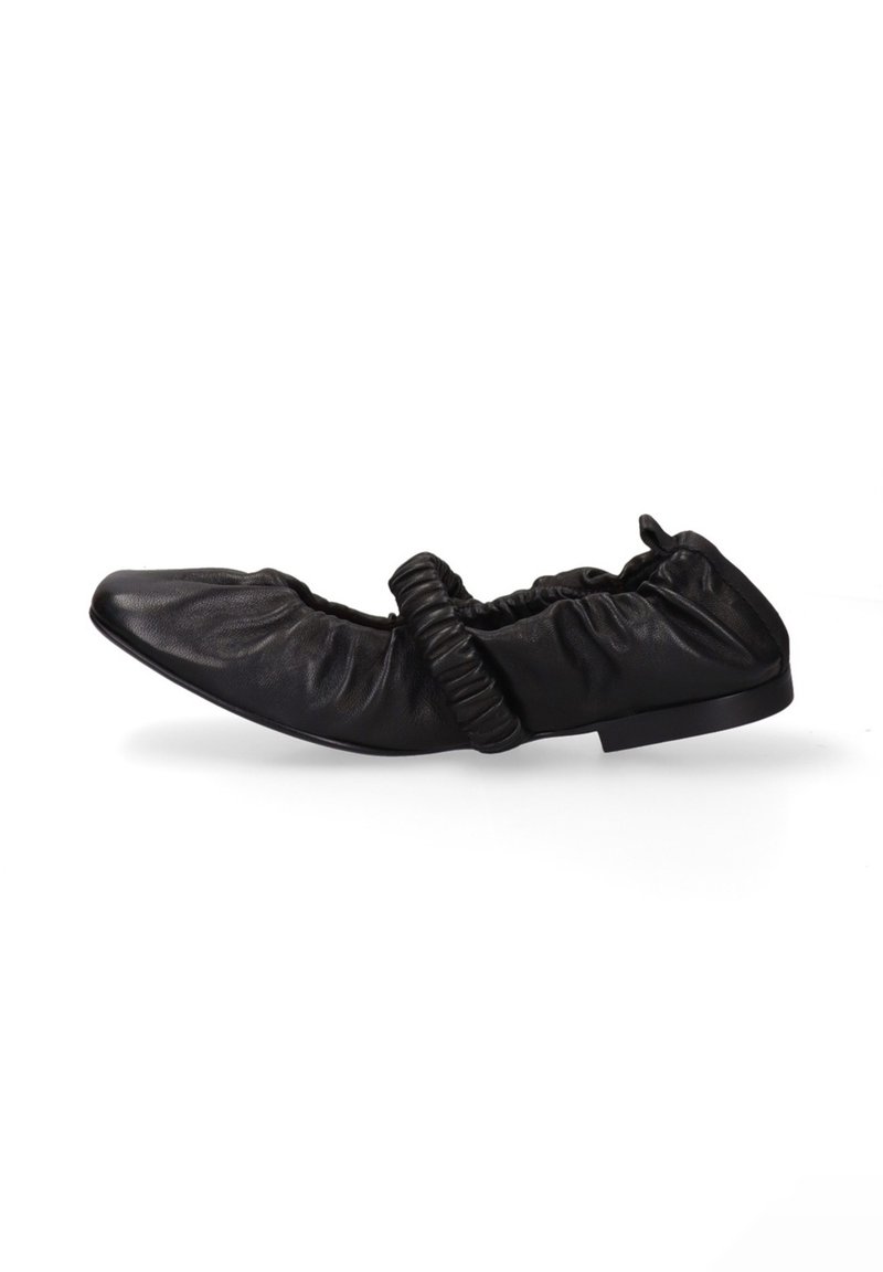 Black leather flat shoe with elastic detailing across the top and gathered texture around the opening on a white background.
