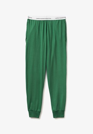 Zielone spodnie dresowe z elastycznymi mankietami i białym pasem z napisem "United Colors of Benetton", pokazane na płasko na białym tle.