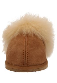 Brown suede slipper with a fluffy cream fur trim, rounded shape, and visible stitching on the back and sides. Soft textured sole.