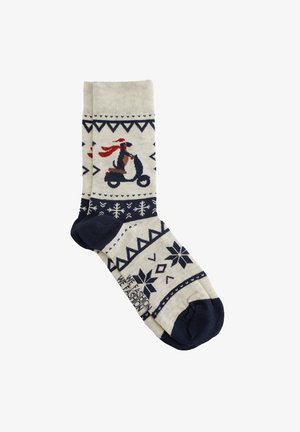 Adīti zeķes ar krēmkrāsas pamatu, uz kurām attēlots pingvīns uz skūtera. Jūras zils papēdis un pirksts, ģeometriskas raksts un sniegpārsliņas visā virsmā.