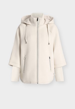 Übergroßer cremefarbener Hoodie mit hohem Kragen, Frontreißverschluss, Kapuze mit Kordelzug und gerippten Ärmeln; verfügt über zwei seitliche Reißverschlusstaschen.