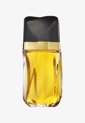 Bouteille de parfum avec un capuchon noir à facettes, un anneau doré et un verre texturé clair. Le liquide est d'une couleur jaune vif.