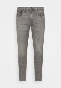Šedé džíny z denimu s úzkým střihem, obsahující pět kapes, jemné omyly a tonální prošívání. Standardní zapínání na knoflík a zip.