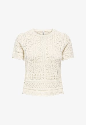 Blondetopp med korte ermer i krem, med innviklede mønstre, rund hals og bølget kant med teksturert strikket stoff.