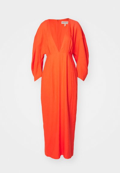 Red linen maxi dress with a deep V-neckline, long sleeves, and a straight silhouette. Features a zipper closure at the back.