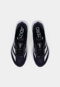 Black running shoes with a textured mesh upper, silver stripes, and a cushioned sole. Features lace closure and "ADIZERO" branding inside.