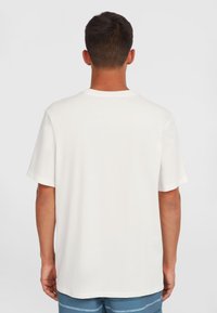 White cotton t-shirt with short sleeves and a crew neckline, featuring a relaxed fit and smooth texture. Plain without patterns or accents.