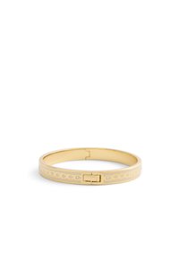 Gold bangle bracelet features a smooth surface, rounded shape, and a clasp closure. Notable details include engraved patterns and accent stones.