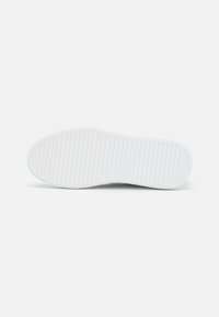 Talpa de pantof din cauciuc alb, cu o suprafață texturată, featuring caneluri orizontale și un design cu vârf rotund. Apariție curată și minimalistă.