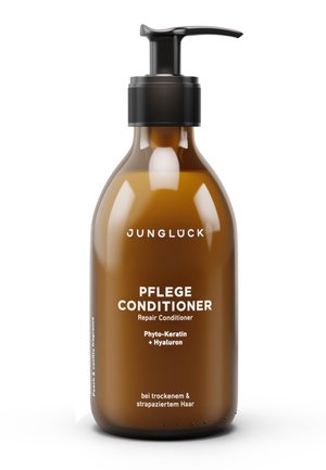 Braune Pumpspenderflasche des Junglück Pflege Repair Conditioners mit Phyto-Keratin und Hyaluron für trockenes und geschädigtes Haar.