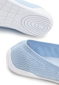 Scarpe slip-on di colore blu chiaro realizzate in materiale a maglia testurizzata, con suola in gomma bianca a motivo ondulato e design superiore flessibile.