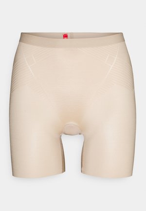 Beige stretch fabric boxer shorts with a seamless design, featuring subtle diagonal patterns and an elastic waistband with a small logo tag.