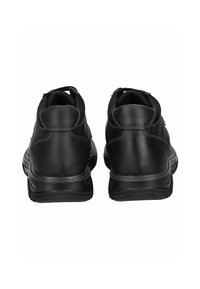 Chaussures en cuir noir avec une surface lisse, des talons arrondis et des cols rembourrés. Elles présentent des semelles en caoutchouc durables et des coutures contrastantes.