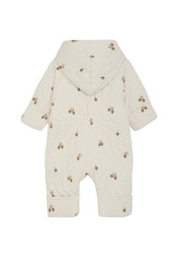 Salopette pour bébé matelassée, de couleur crème, avec capuche. Présente de petits motifs de feuilles brunes et de glands. Manches à revers et taille élastique.