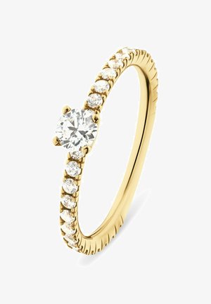 Bague en or ornée d'un diamant rond central, flanqué de petits diamants le long d'un anneau texturé au design en torsion.