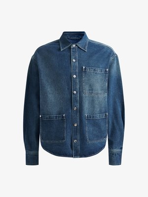 Denim shirt in medium wash blue with long sleeves, button-down front, and two front pockets. Features silver-tone button accents.