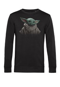 Sort sweatshirt med et grafisk motiv af en grøn karakter med store ører, detaljerede øjne og iført en lysegrå kappe.
