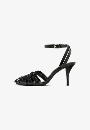 Black leather high-heeled sandal with an ankle strap, featuring woven straps across the toe, a smooth finish, and a pointed toe shape.