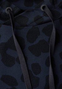 Námořnická modrá mikina s černým leopardím potiskem, vybavená kapucí se stahovací šňůrkou a strukturovanou tkaninou. Design zahrnuje kulaté konce stahovacích šňůrek.