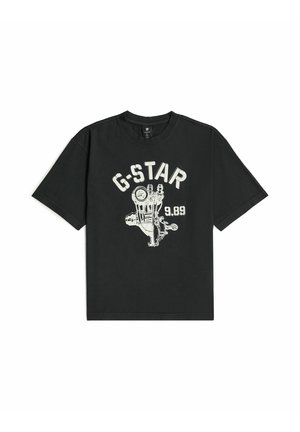 T-shirt noir à manches courtes avec un graphisme de main mécanique blanche, le texte "G-STAR" au-dessus et "9.89" à droite sur le devant.