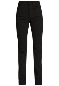 Jeans en denim noir avec une taille haute, une coupe slim, un design à cinq poches et des coutures contrastées. Texture lisse et sans logos ni motifs visibles.