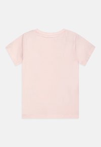 Light pink short-sleeve T-shirt made from soft cotton, featuring a round neckline and a plain, smooth texture without embellishments.