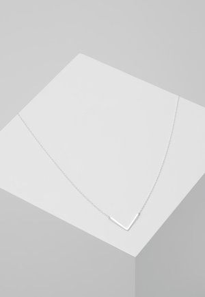 Silver V-shaped necklace on a thin chain, featuring a sleek, minimalist design with a polished finish. Shown on a light gray background.