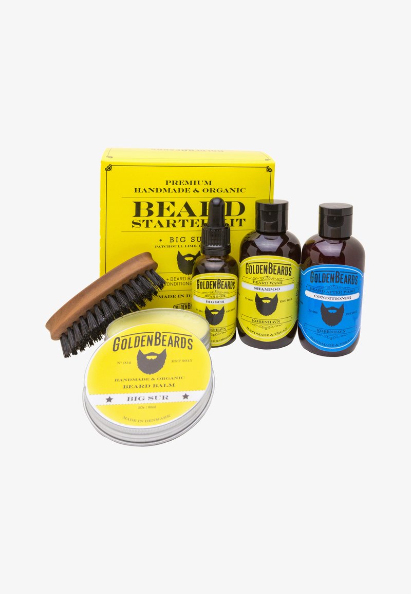 Skäggstartkit i gul förpackning som inkluderar en träkam, skäggolja, schampo, balsam och balm i svarta och gula flaskor.