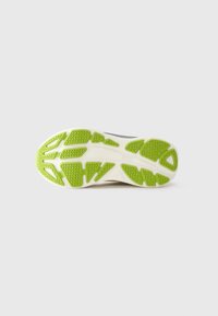 Gray and white athletic shoe sole with green rubber traction patterns on a plain white background.