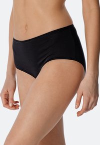 Bas de bikini hipster noir texturé avec une taille lisse, présentant des détails de rayures subtiles et une coupe taille moyenne.