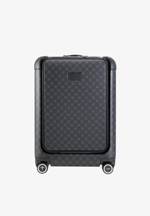 Black patterned hard-shell suitcase with a textured finish, featuring a top handle, zipper closure, and four wheels for mobility.