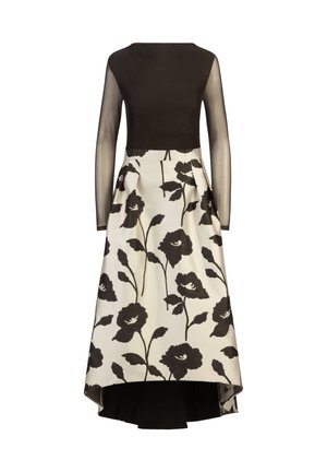 Vestido negro de manga larga con un cuerpo transparente, que presenta una falda blanca adornada con patrones florales negros y un dobladillo asimétrico.