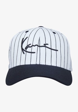 Witte baseballpet met verticale zwarte streepjes, een zwarte gebogen klep en zwarte geborduurde handtekening-achtige tekst op de voorkant.