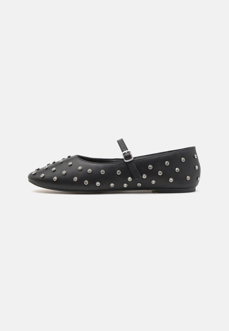 Black flats with a rounded toe, made of leather, featuring a strap with a buckle. Embellished with silver studs evenly across the surface.