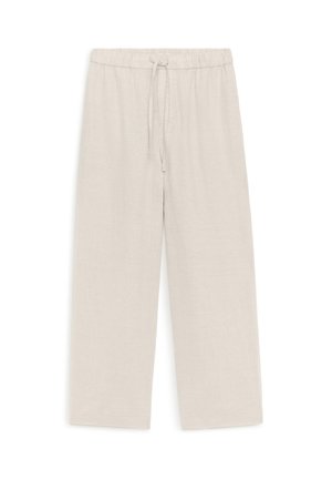 Pantalon ample beige clair à taille élastique avec cordon, en tissu texturé, présenté sur un fond blanc.