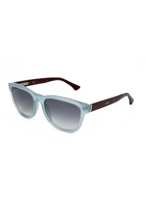 Occhiali da sole cat-eye con montatura traslucida azzurro chiaro e lenti sfumate scure, con aste dal motivo tartarugato.