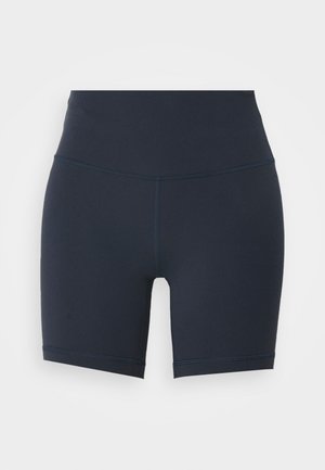 Marinblå högmidjade träningsshorts tillverkade av stretchigt material, med en slät textur och kontrasterande sömmar längs kanterna.